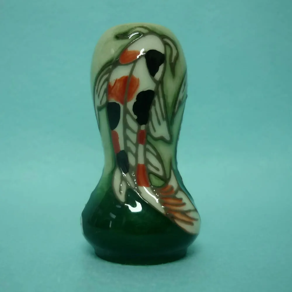 A Miniature Moorcroft Vase with Box and Sleeve.